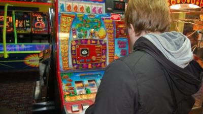 Man at fruit machine