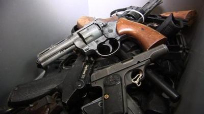 Some replica guns about to be burnt down at a foundry