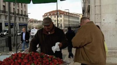 A man selling strawberries