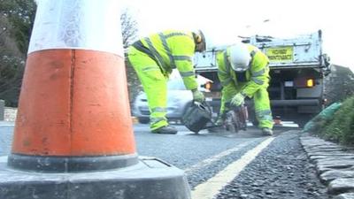 Pothole being repaired