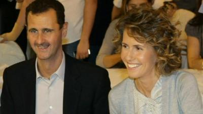 President Assad of Syria smiling with his wife Asma.