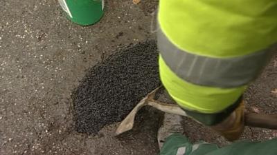 A pothole being repaired