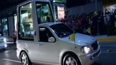 Pope sits in Popemobile in Mexico.