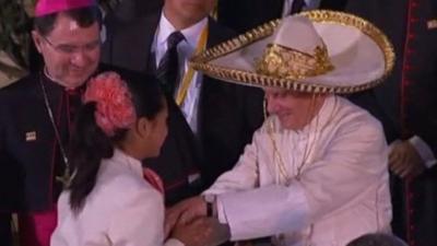 The Pope being presented with a Mexican sombrero