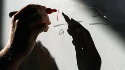 Teacher writing on white board