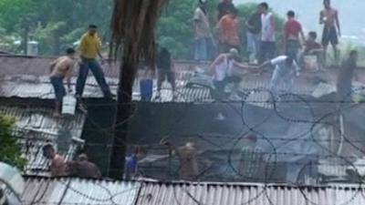 A fire being put out at the San Pedro Sula prison in Honduras.