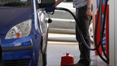 Man filling car with fuel