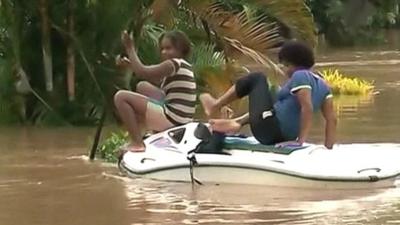 People on a boat in flooded Fiji