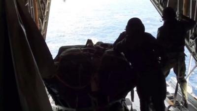 The US coastguard drops medical supplies to the Geraldton Western Australia yacht on the Pacific Ocean