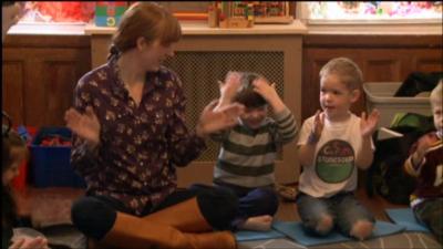 parent sits with children