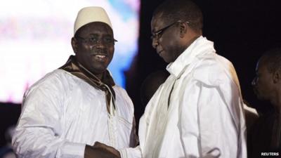 Senegalese presidential challenger Macky Sall (L) shakes hands with Grammy award-winning musician and political backer Youssou Ndour