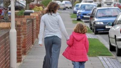 Woman walking with child