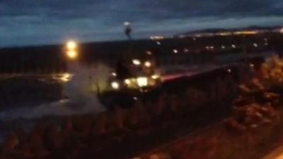 Two lifeboats and a helicopter were called at 20:30 BST after the ship hit a rock near a quarry jetty at Llanddulas