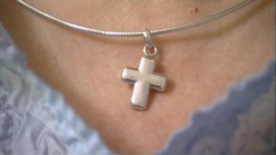 Cross pendant on necklace