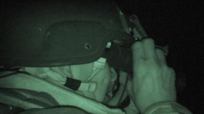 An officer carrying out a night raid