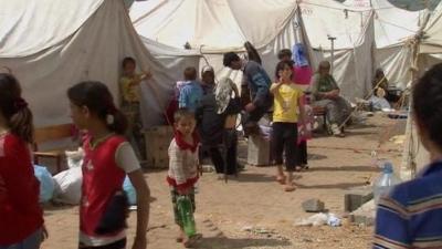 Refugees in a camp on the Turkey-Syria border