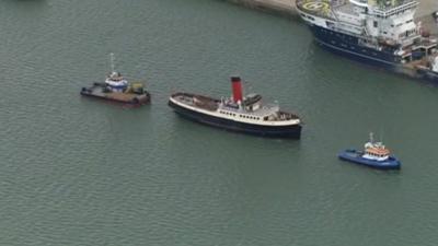 The tug Calshot leading a flotilla away from berth 44 where Titanic was