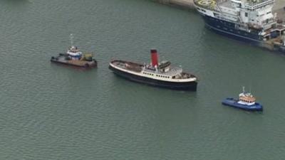 The tug Calshot leading a flotilla away from berth 44 where Titanic was