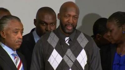 Tracy Martin reacts to the news that his son's shooter is charged with second degree murder 11 April 2012