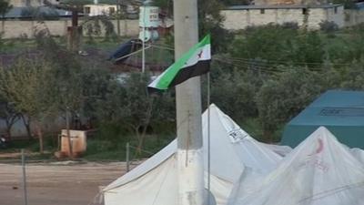 Syrian flag at the border between Syria and Turkey, moments after the UN deadline for a complete ceasefire passed.