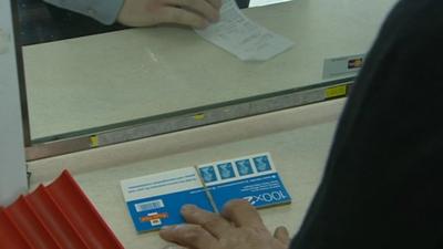 Hundreds of stamps on counter in Post Office