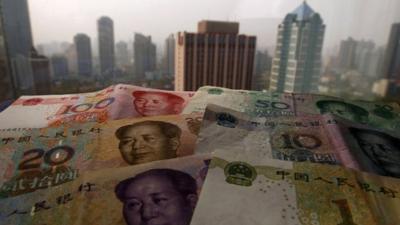 Yuan banknotes against Shanghai skyline