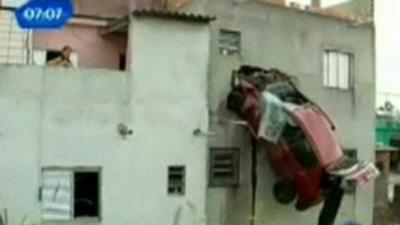 Car stuck to side of house in Brazil