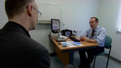 A patient receives his diagnosis from a doctor