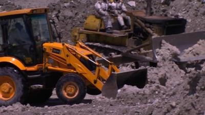 Diggers searching for bodies
