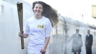 Helana Scott carries the torch during the rehearsal at the Great Central Railway station in Leicester