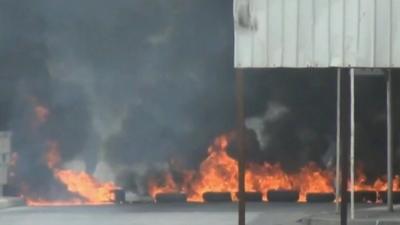 Tyres on fire in the streets of Manama