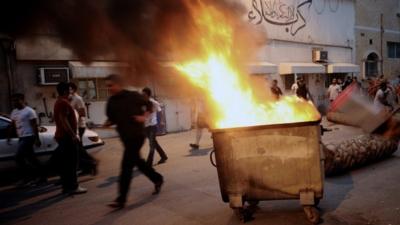 Protesters clash with riot police in Manama