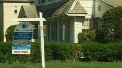 House and 'for sale' sign