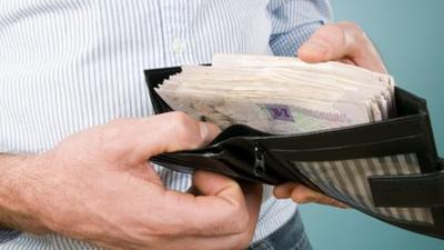 Man with cash in his wallet