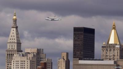 Nasa shuttle Enterprise rides on top of a modified 747 over the Manhattan skyline