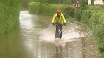 Cyclist in floodwaters