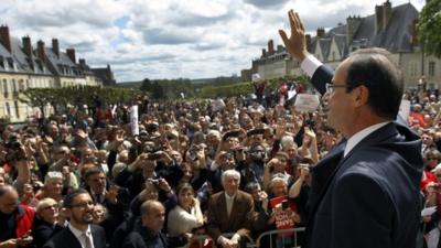 French Socialist Party candidate for the 2012 presidential elections Francois Hollande waves after delivering his speech during a meeting in Nevers