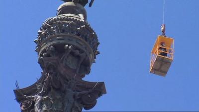 Firefighters in crane rescue tourists from top of Columbus monument