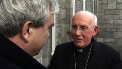 Darragh MacIntyre (L) speaks to Cardinal Sean Brady (R)