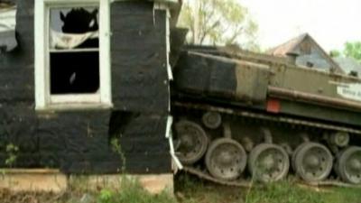 The tank driving through the house