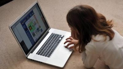 A young girl browses the internet