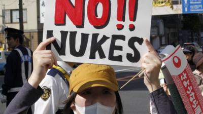 Protester holds 'No Nukes' sign in Japan