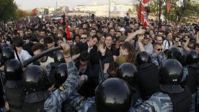 Riot police scuffle with protesters