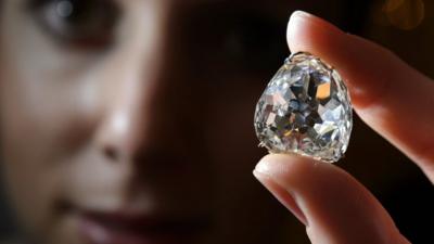 Model poses with the Beau Sancy diamond during a Sotheby"s auction press preview in Geneva