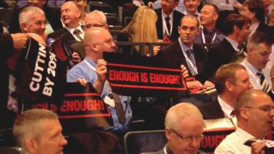 Members of the Police Federation hold banners reading "enough is enough"