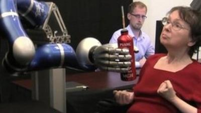 Cathy Hutchinson using a robot arm to take a sip of coffee - Courtesy Brown University