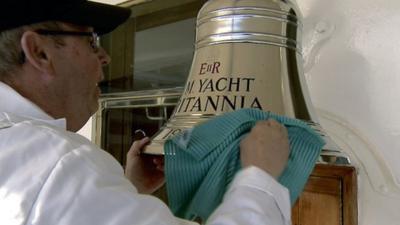 Crewman polishes a bell on the Royal Yacht Britannia