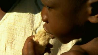 Malawi baby eating bread
