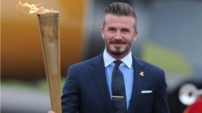 David Beckham carries the Olympic torch as it arrives at RNAS Culdrose