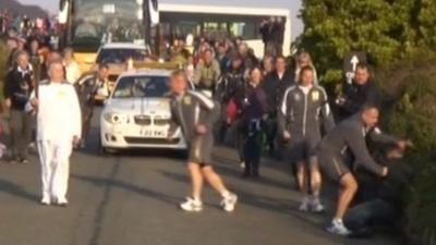 Olympic torch officers tackle man